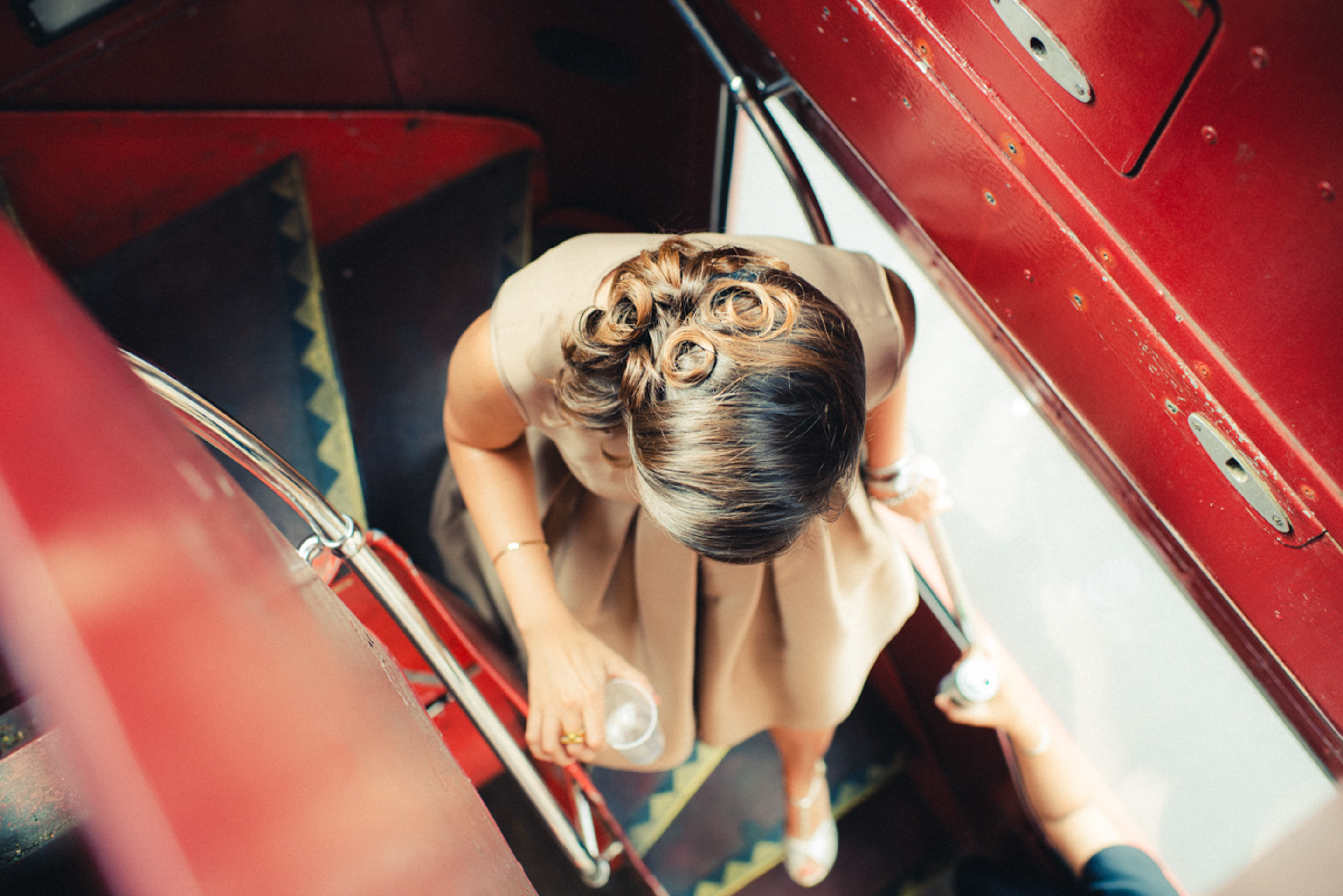 Elegant lady going down stairs of a double deck bus in a london wedding