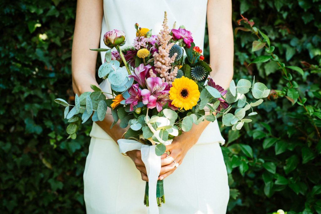 Marrié tenant bouquet de fleur, eucalyptus et tournesol