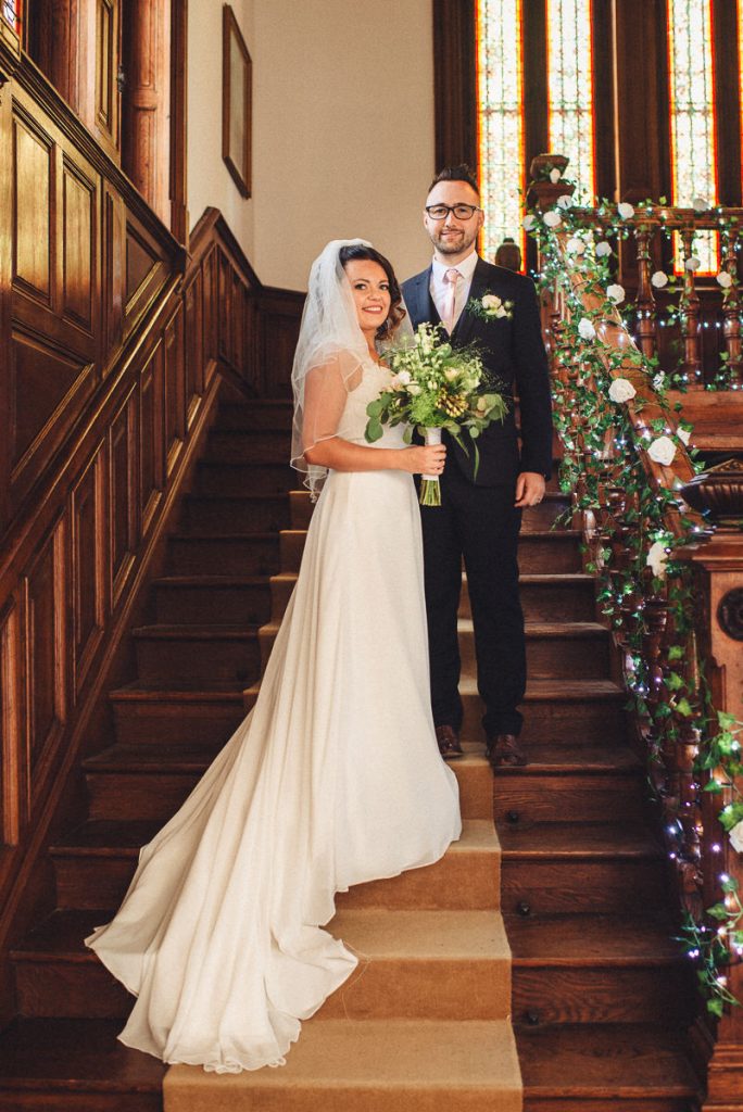 Emily Florent Married couple in grand staircase at Chateau Saint Michel South of France