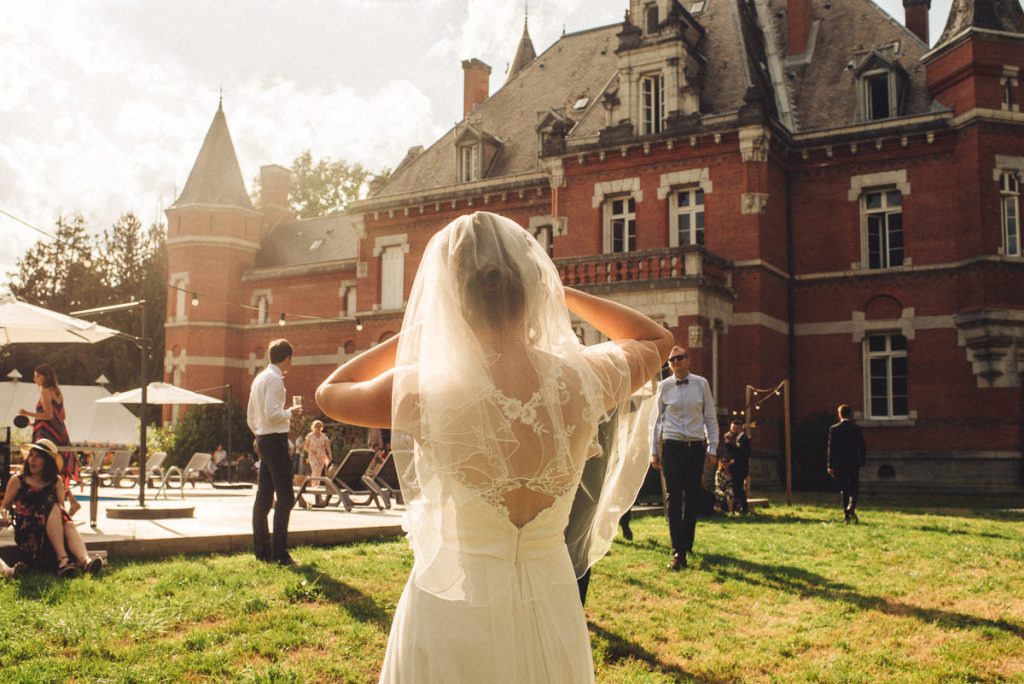 The bride looking into the sun during her wedding at Chateau Saint Michel South of France